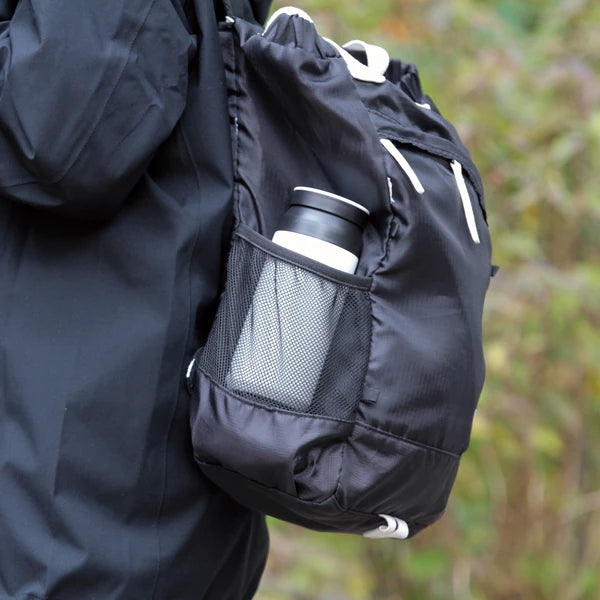 Stainless steel bottle stored in the side pocket of a backpack